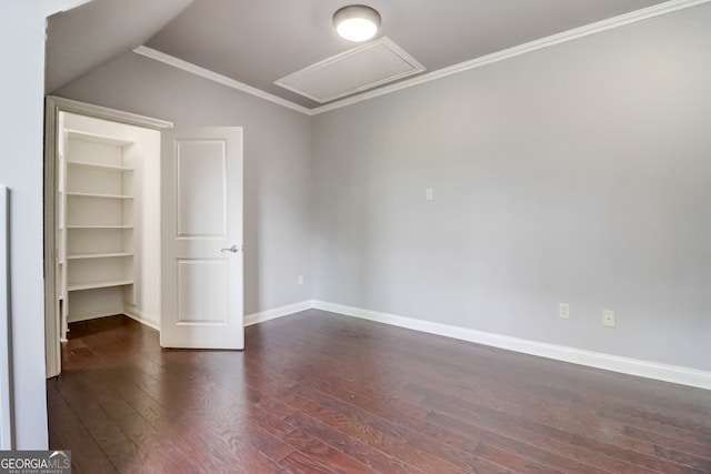 interior space with dark hardwood / wood-style floors, built in features, crown molding, and vaulted ceiling