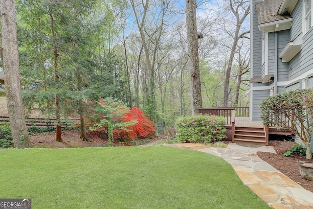 view of yard featuring a wooden deck