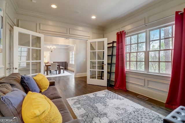 interior space featuring plenty of natural light, dark wood-type flooring, and french doors