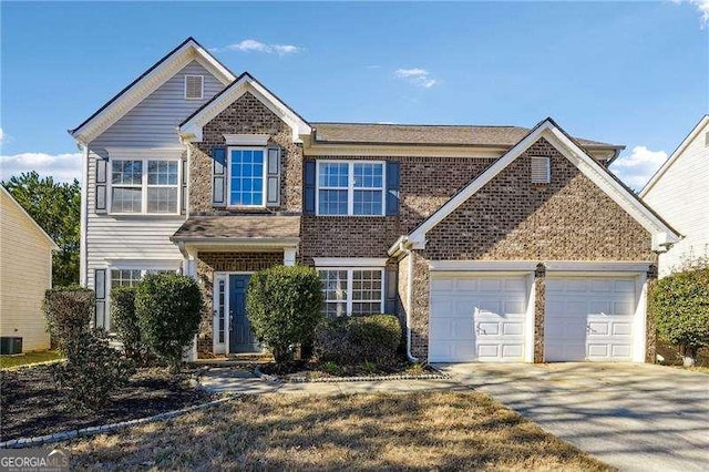 view of front of home featuring a garage and central AC unit