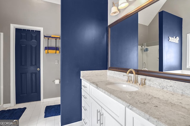 bathroom featuring vanity, a shower with shower door, and tile patterned floors