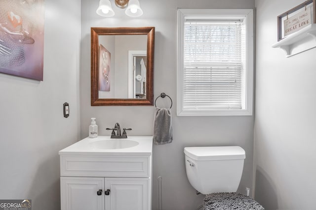 bathroom featuring vanity and toilet