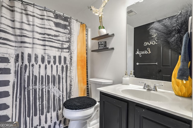 bathroom with vanity, toilet, and a shower with shower curtain