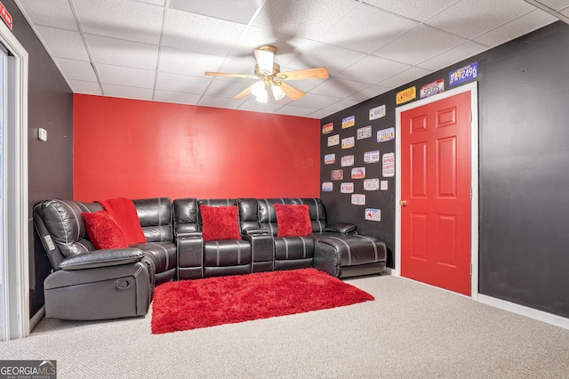 carpeted living room featuring a drop ceiling and ceiling fan