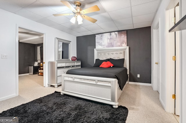 carpeted bedroom featuring a paneled ceiling and ceiling fan