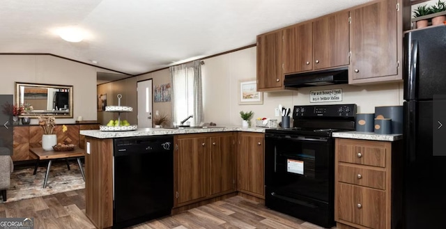 kitchen featuring vaulted ceiling, kitchen peninsula, dark hardwood / wood-style flooring, and black appliances