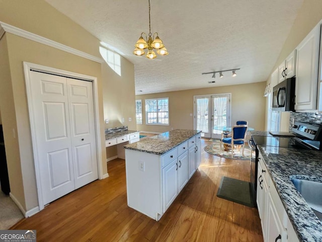 kitchen featuring white cabinets, a textured ceiling, and appliances with stainless steel finishes