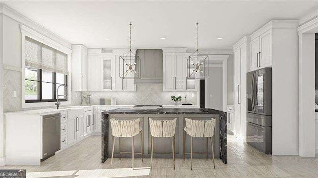 kitchen with white cabinets, a center island, appliances with stainless steel finishes, a kitchen breakfast bar, and sink