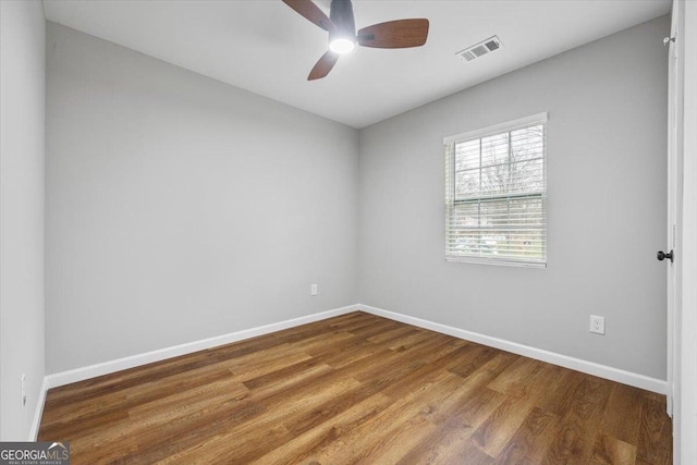 spare room with ceiling fan and hardwood / wood-style floors