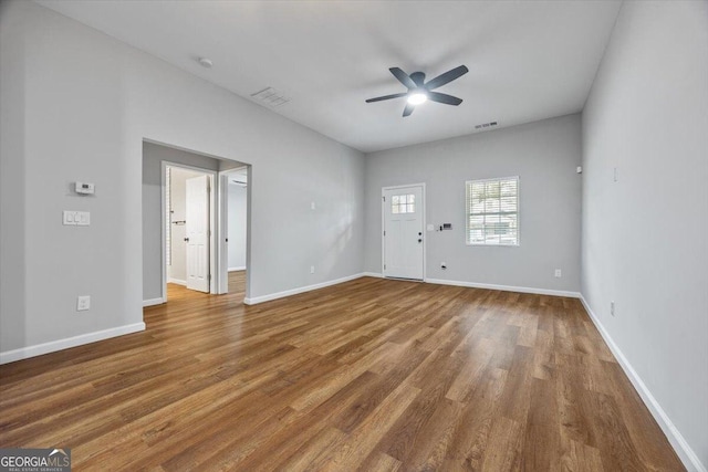 empty room with ceiling fan and hardwood / wood-style floors