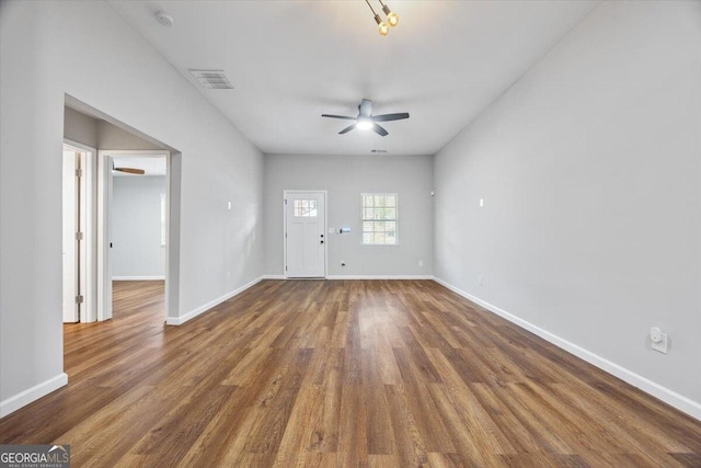 empty room with ceiling fan and dark wood-type flooring