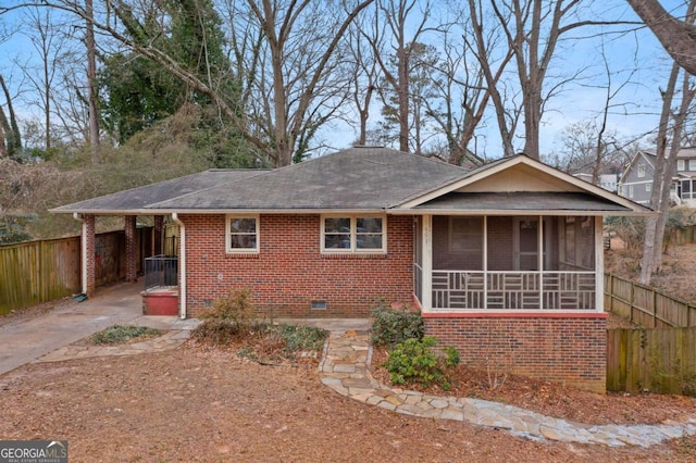 view of front of property featuring a sunroom and a carport