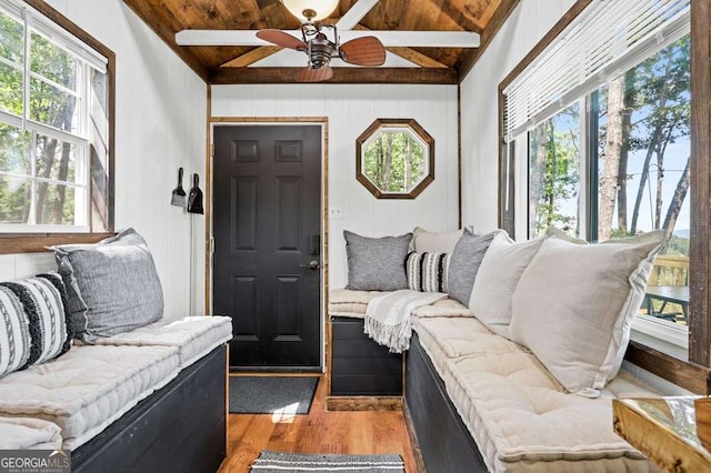 living room with plenty of natural light, lofted ceiling with beams, and wood ceiling