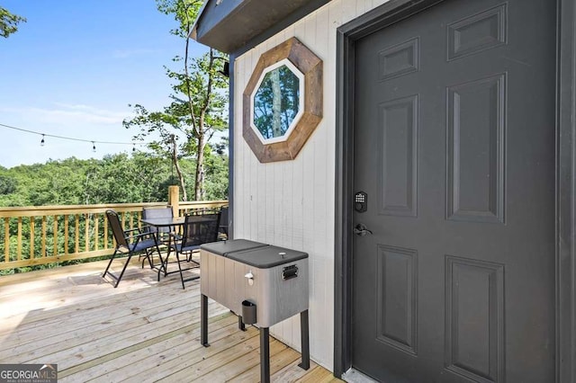 view of exterior entry with a wooden deck