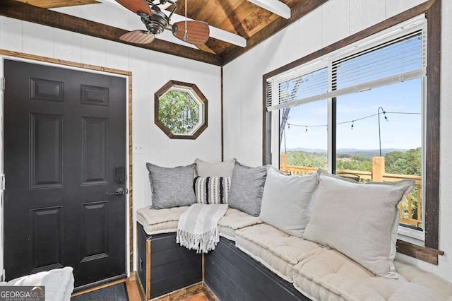 interior space with wooden ceiling, lofted ceiling with beams, and ceiling fan