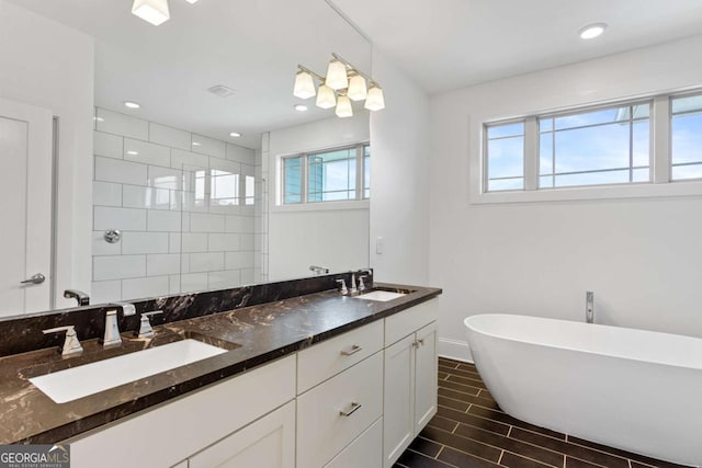 bathroom featuring vanity and shower with separate bathtub