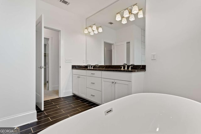 bathroom featuring vanity and a bathtub