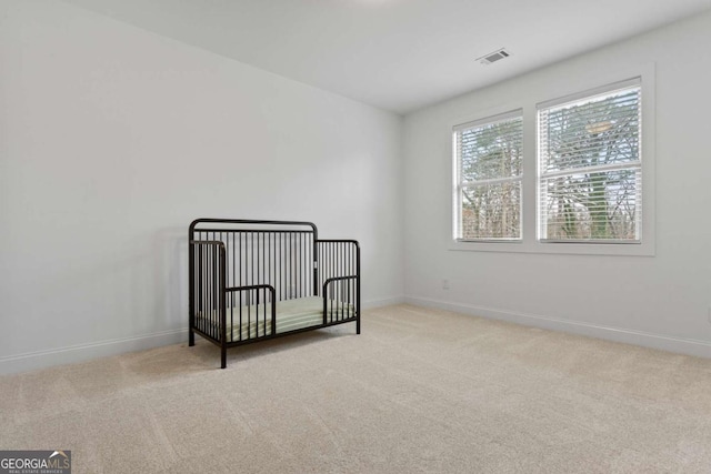 interior space featuring a nursery area and light carpet