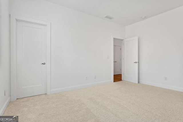 unfurnished bedroom with light colored carpet