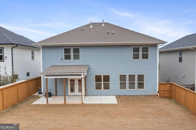 rear view of property featuring central air condition unit and a patio