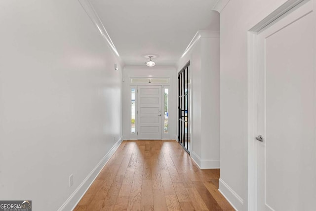 entryway featuring light hardwood / wood-style flooring and crown molding