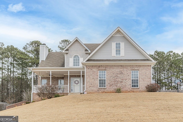 view of front of house featuring a front lawn and covered porch