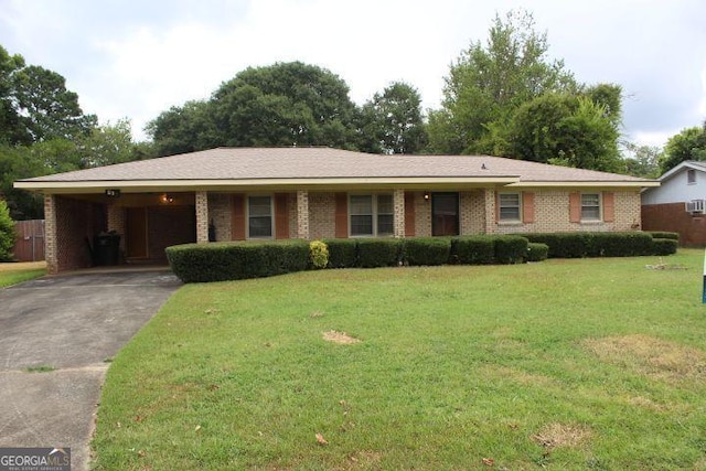 ranch-style home with a carport and a front lawn