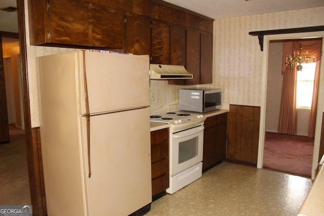 kitchen featuring white appliances and dark brown cabinetry