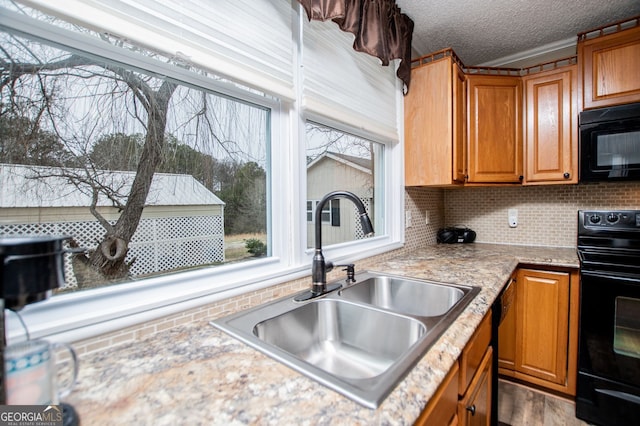 kitchen featuring decorative backsplash, sink, a textured ceiling, and black appliances