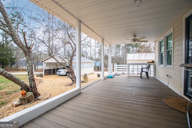 wooden deck featuring ceiling fan