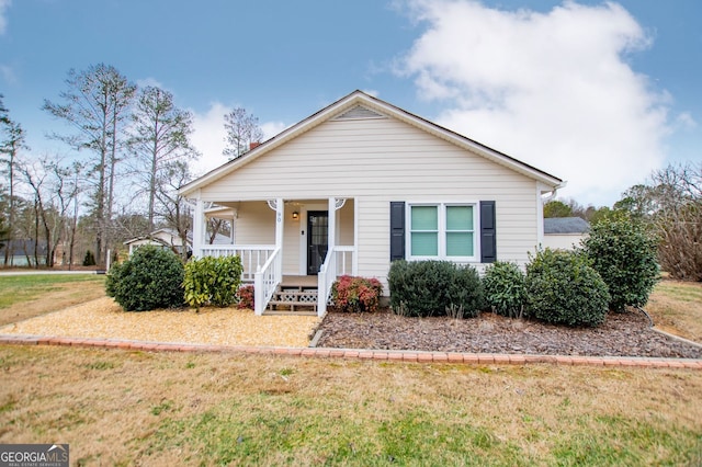 view of front facade with a front lawn and a porch