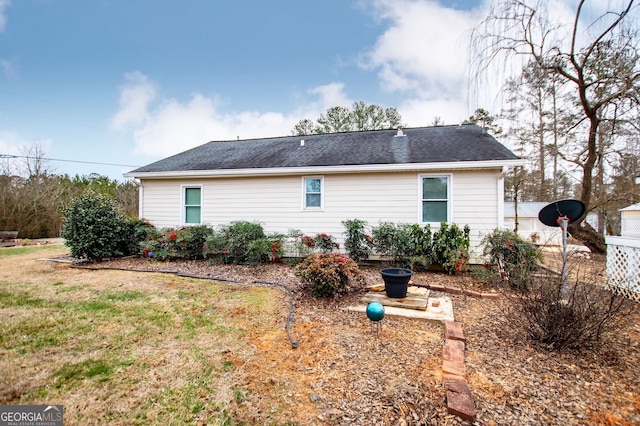 back of house featuring a yard