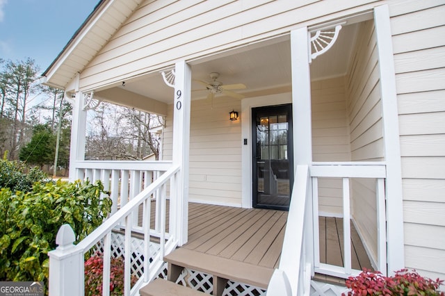 view of exterior entry with ceiling fan and a porch