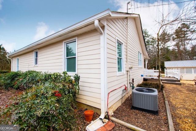 view of side of home featuring central AC