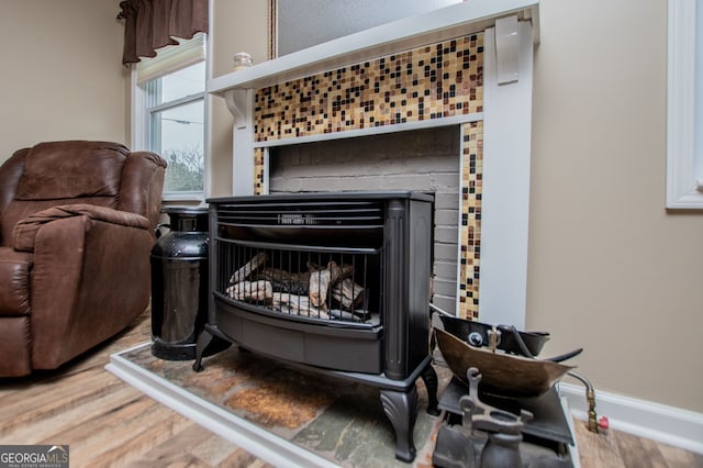 interior details featuring hardwood / wood-style floors and a tile fireplace