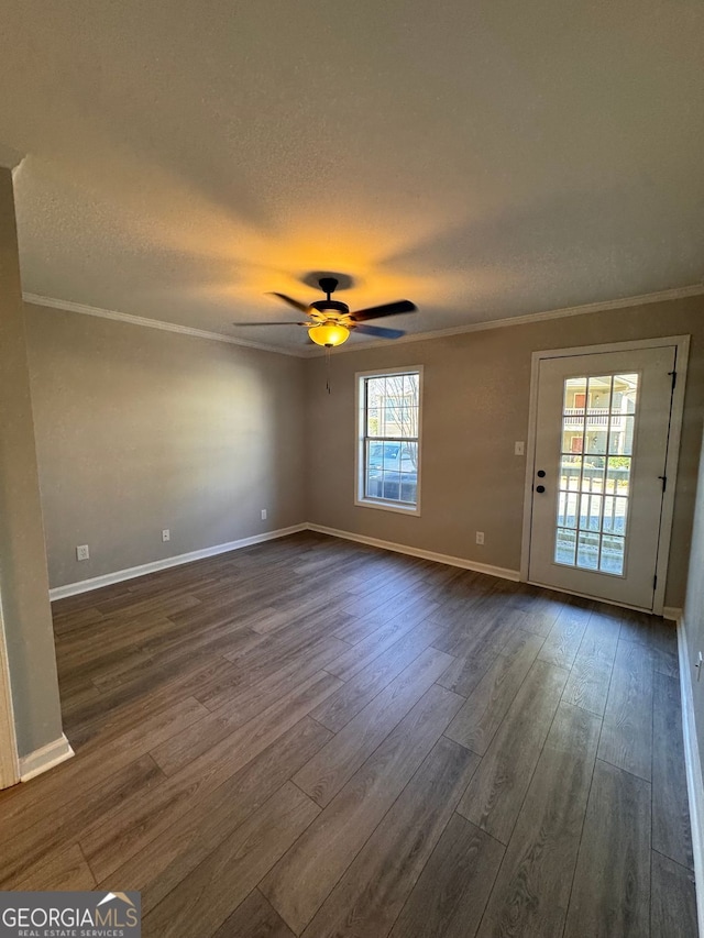 unfurnished room featuring ceiling fan, crown molding, and dark hardwood / wood-style flooring