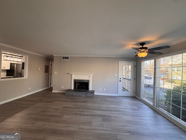 unfurnished living room featuring ornamental molding, dark hardwood / wood-style floors, and ceiling fan