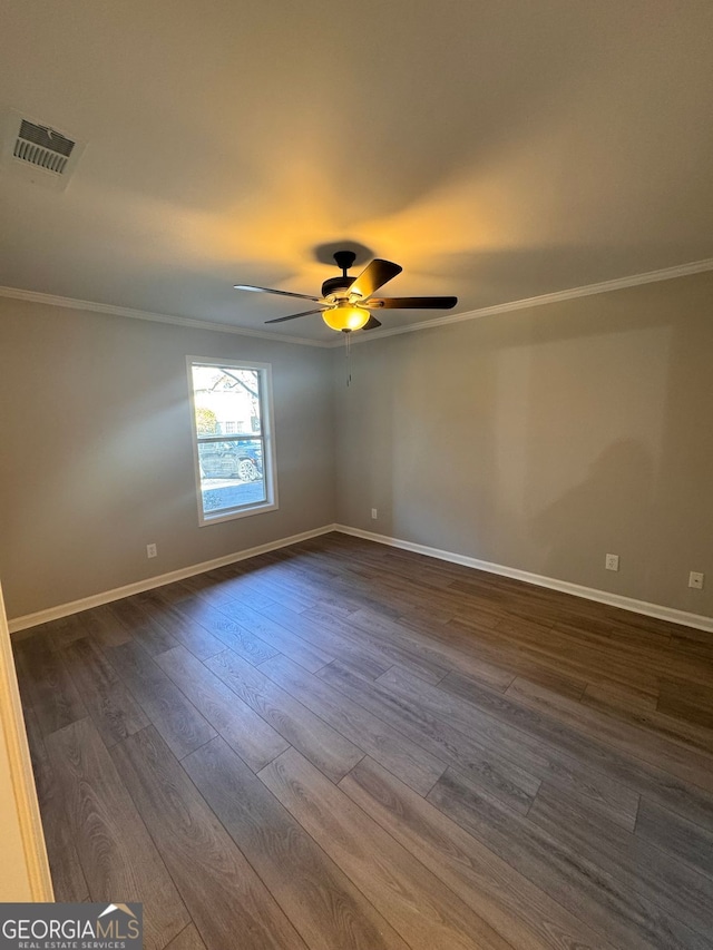 spare room with crown molding, ceiling fan, and dark hardwood / wood-style flooring