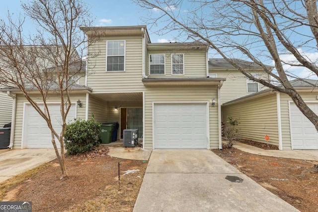 view of front of property with a garage and cooling unit