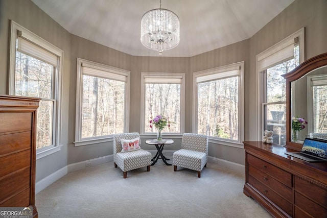 sitting room with light colored carpet, a notable chandelier, and a healthy amount of sunlight