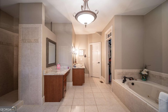 bathroom with shower with separate bathtub, tile patterned floors, and vanity