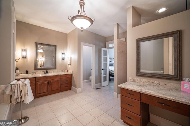 bathroom featuring toilet, tile patterned flooring, and vanity