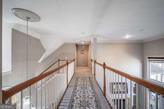 corridor featuring lofted ceiling and ornamental molding