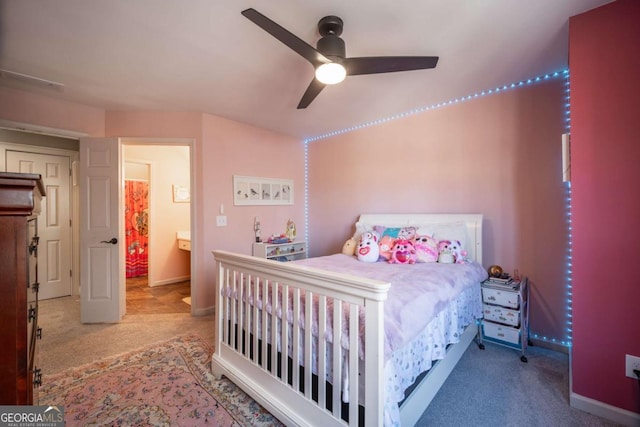 bedroom featuring ceiling fan, carpet floors, and ensuite bath