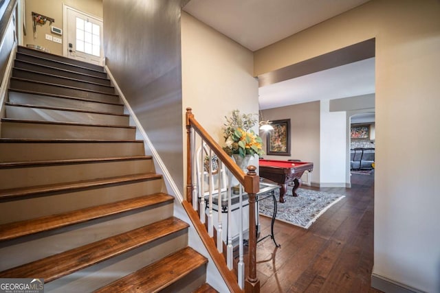 stairs with hardwood / wood-style floors and billiards