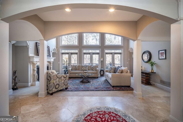 living room with a towering ceiling and french doors