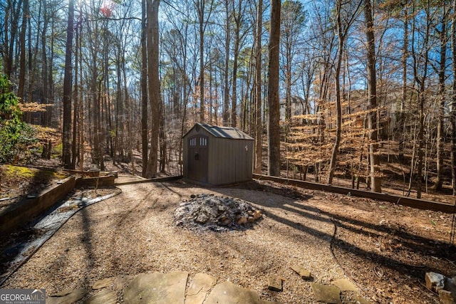 view of yard featuring a fire pit and a storage unit