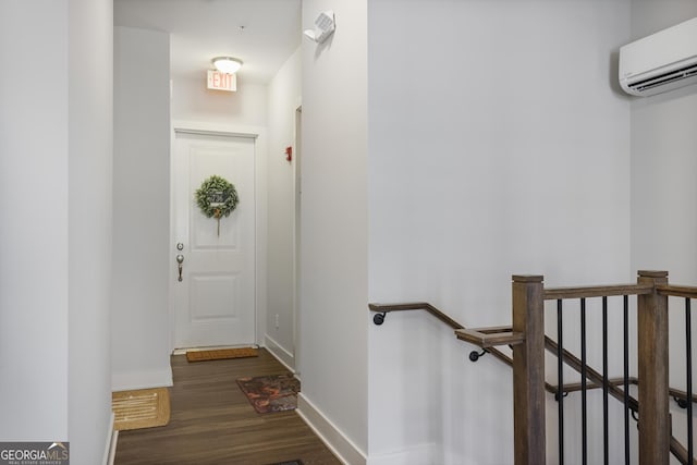 interior space with dark wood-type flooring and a wall mounted air conditioner