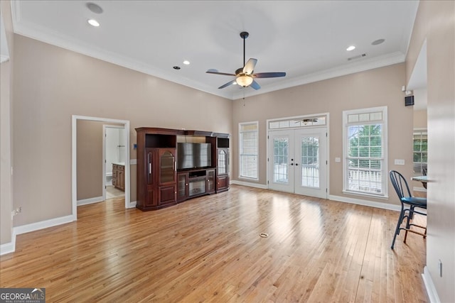 living room with light hardwood / wood-style floors, ceiling fan, ornamental molding, and french doors