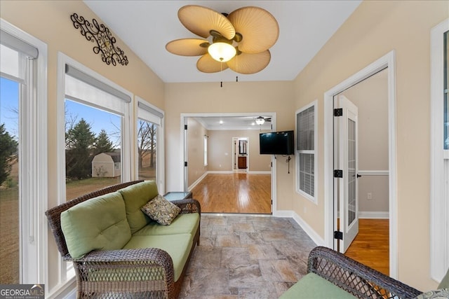 interior space with ceiling fan